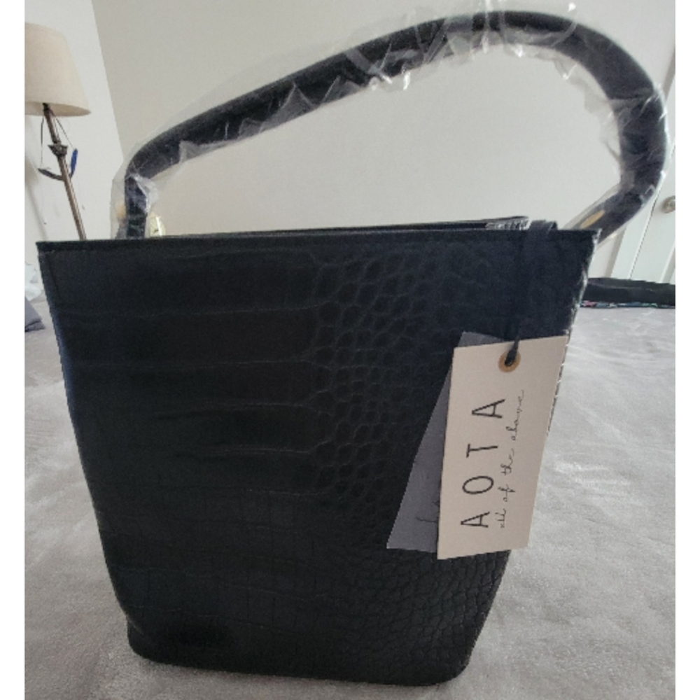 AOTA Elena bucket bag in black croc-embossed vegan leather. 